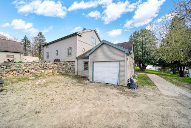 8825 Mills Rd, Manitou Beach, MI 49253 - view of property exterior featuring an attached garage, driveway, and an outdoor structure