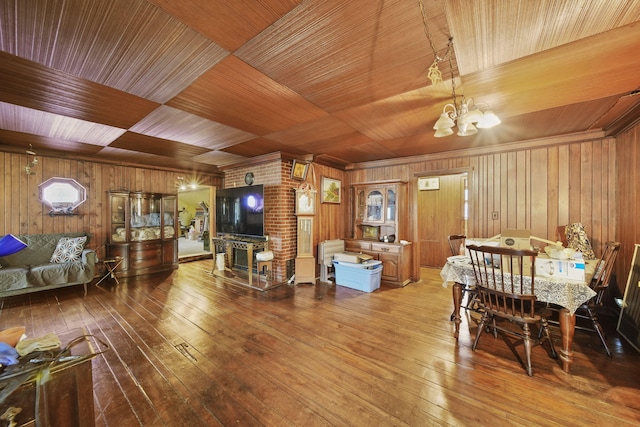 8825 Mills Rd, Manitou Beach, MI 49253 - dining area with a chandelier, wooden walls, wooden ceiling, and hardwood / wood-style flooring