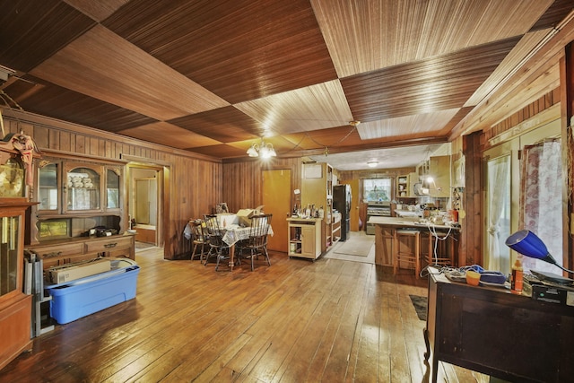 8825 Mills Rd, Manitou Beach, MI 49253 - dining area featuring wood ceiling, wood walls, and wood-type flooring