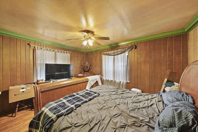 8825 Mills Rd, Manitou Beach, MI 49253 - bedroom featuring wood finished floors, wooden walls, and ceiling fan