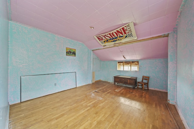 8825 Mills Rd, Manitou Beach, MI 49253 - bonus room with hardwood / wood-style flooring, vaulted ceiling, and baseboards