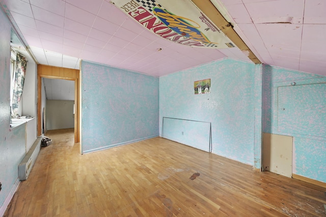 8825 Mills Rd, Manitou Beach, MI 49253 - bonus room featuring hardwood / wood-style flooring, vaulted ceiling, and baseboards
