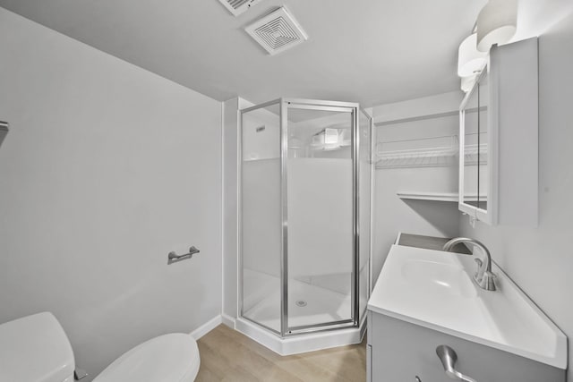 8825 Mills Rd, Manitou Beach, MI 49253 - full bathroom featuring toilet, a stall shower, vanity, wood finished floors, and baseboards