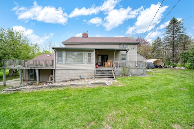 8825 Mills Rd, Manitou Beach, MI 49253 - rear view of property featuring a wooden deck, a yard, and a chimney