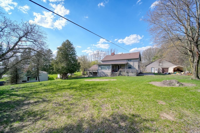 8825 Mills Rd, Manitou Beach, MI 49253 - view of grassy yard with an outbuilding