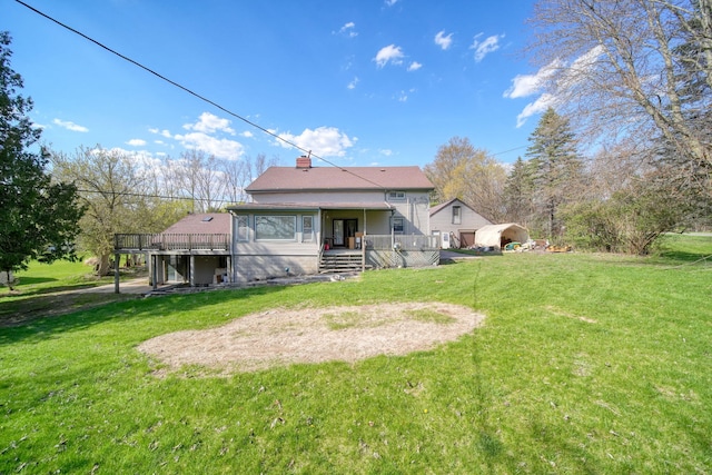 8825 Mills Rd, Manitou Beach, MI 49253 - back of property featuring a yard, a chimney, a wooden deck, and covered porch