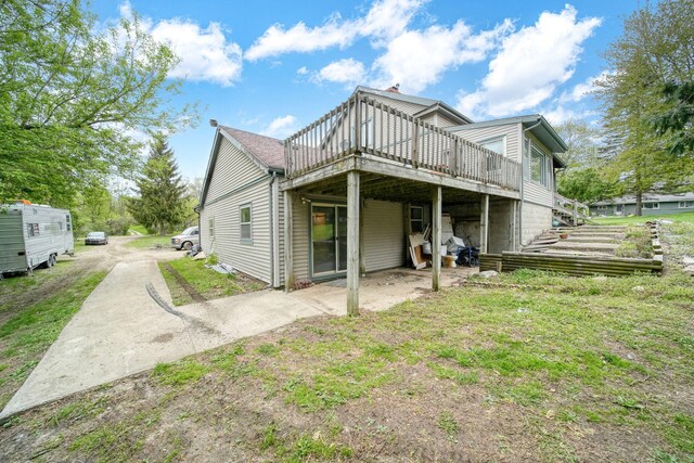 8825 Mills Rd, Manitou Beach, MI 49253 - rear view of house with a wooden deck