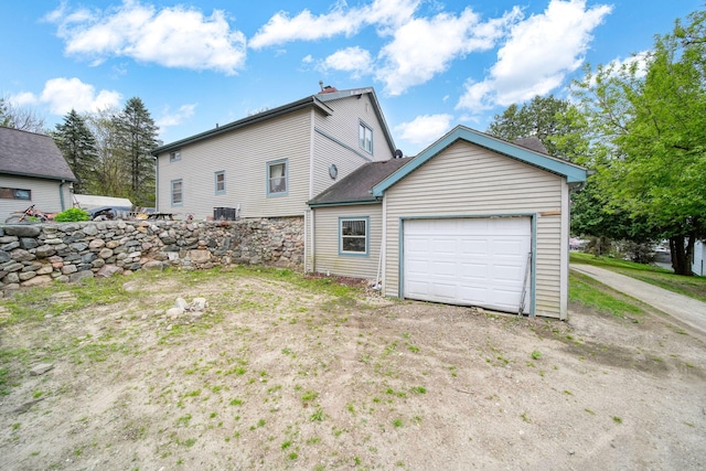 8825 Mills Rd, Manitou Beach, MI 49253 - rear view of property featuring dirt driveway and a garage