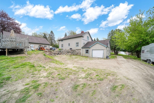 8825 Mills Rd, Manitou Beach, MI 49253 - back of property with dirt driveway and a garage