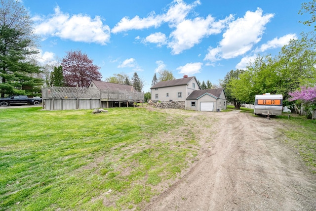 8825 Mills Rd, Manitou Beach, MI 49253 - view of grassy yard with a garage and driveway