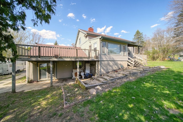 8825 Mills Rd, Manitou Beach, MI 49253 - rear view of house with a chimney, a yard, stairs, a deck, and a patio