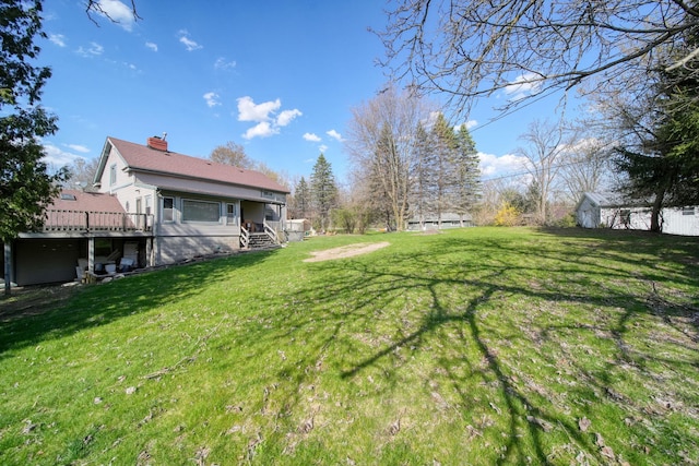 8825 Mills Rd, Manitou Beach, MI 49253 - view of green lawn featuring a deck