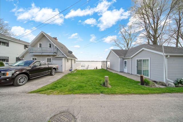 8825 Mills Rd, Manitou Beach, MI 49253 - view of side of property featuring a chimney and a yard