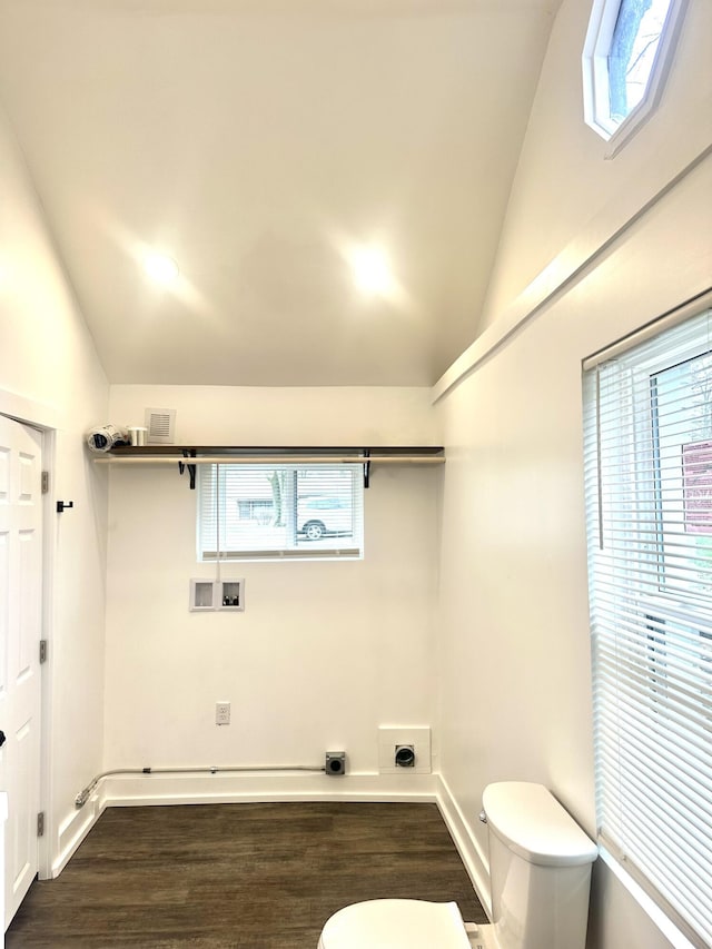 interior space with dark wood finished floors, a wealth of natural light, hookup for a washing machine, and electric dryer hookup