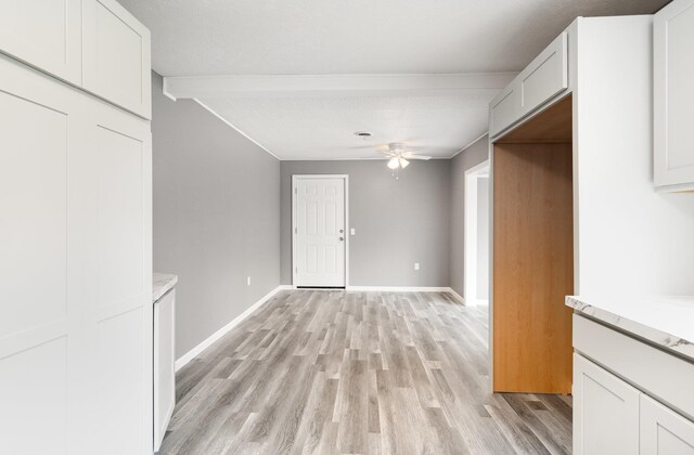 4345 W Mcnally Rd, Coleman, MI 48618 - empty room with baseboards, a ceiling fan, beam ceiling, and light wood-style flooring