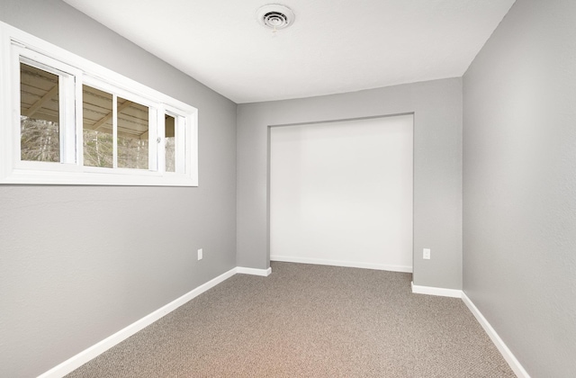 4345 W Mcnally Rd, Coleman, MI 48618 - empty room featuring carpet floors, visible vents, and baseboards
