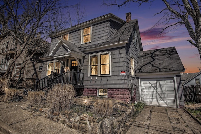 view of front of property featuring fence, driveway, a chimney, and a garage
