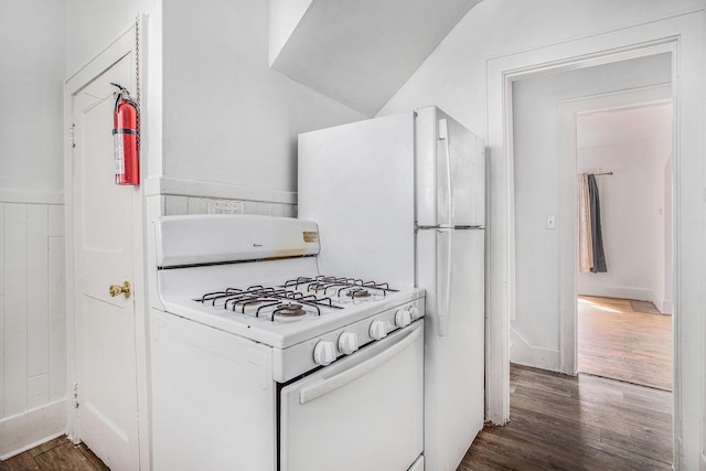 kitchen with white gas stove and wood finished floors