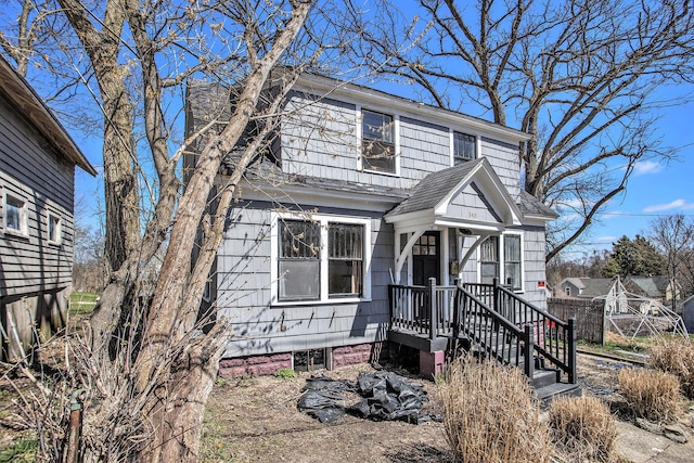 view of front of home featuring roof with shingles