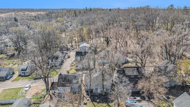 birds eye view of property featuring a residential view and a wooded view