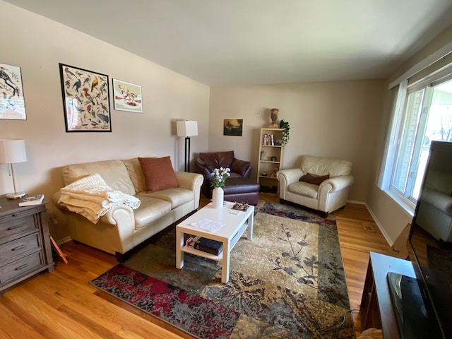 living room featuring light wood-style flooring and baseboards