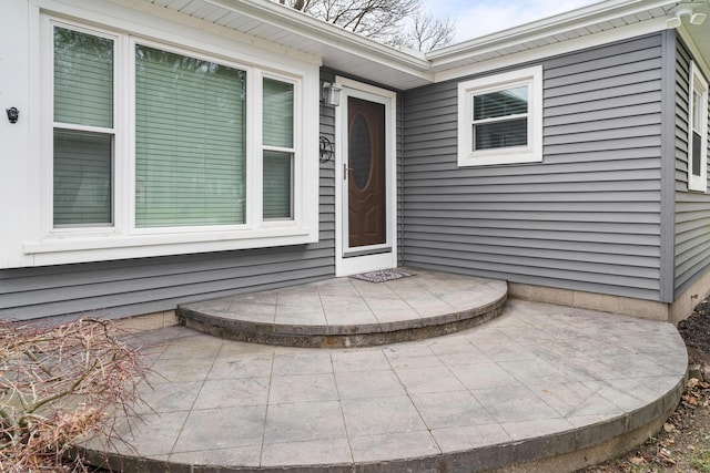view of exterior entry featuring a patio