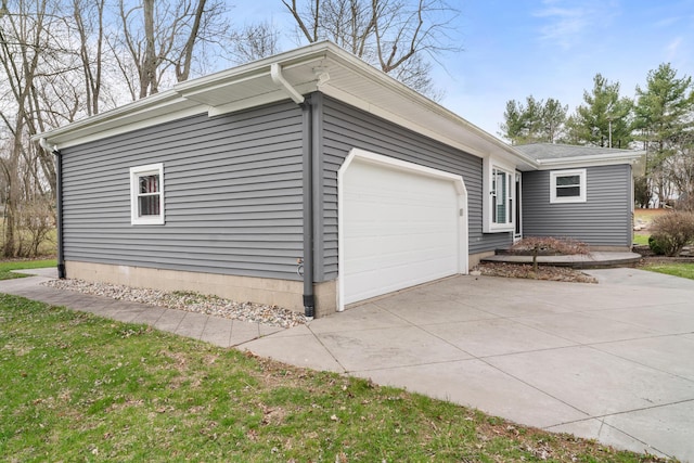 view of home's exterior with an attached garage and driveway