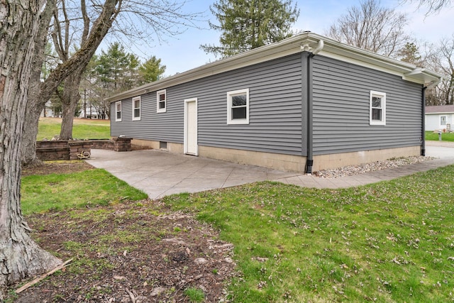 back of property featuring a patio area and a yard