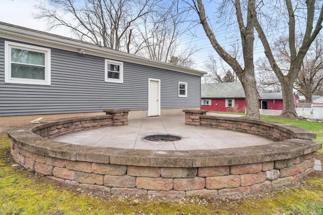 rear view of house featuring a patio area and an outdoor fire pit
