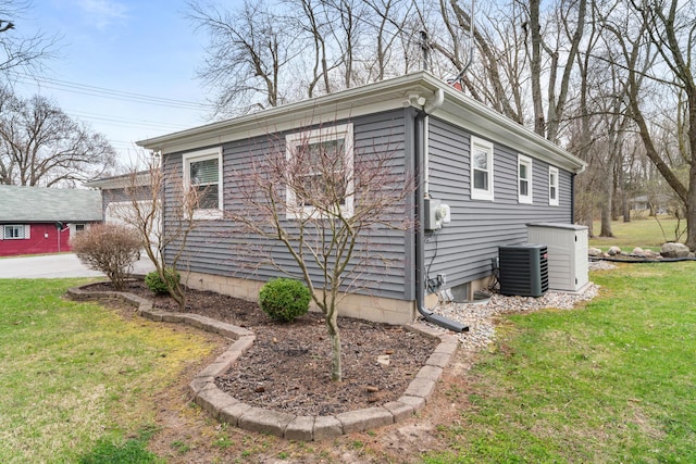 view of property exterior featuring a lawn and central AC