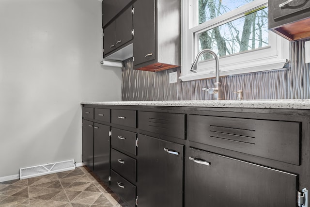 kitchen with baseboards and visible vents