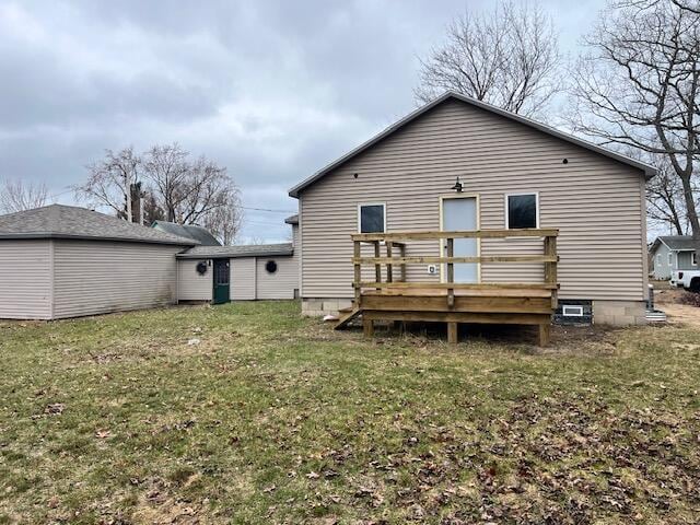 back of house with a wooden deck and a yard