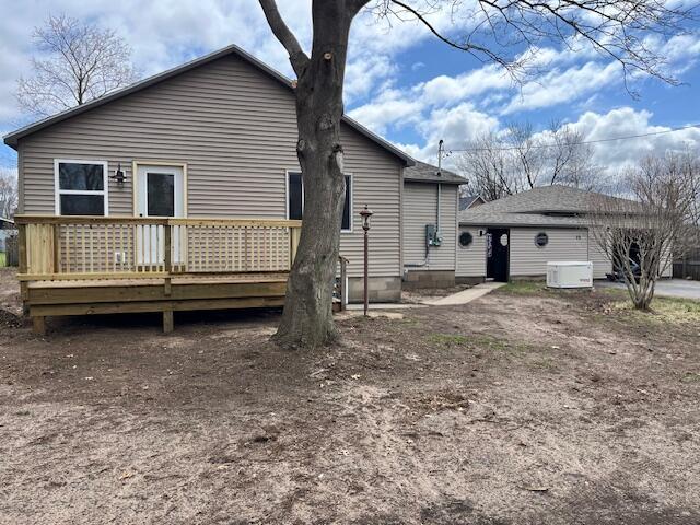 back of house featuring a wooden deck