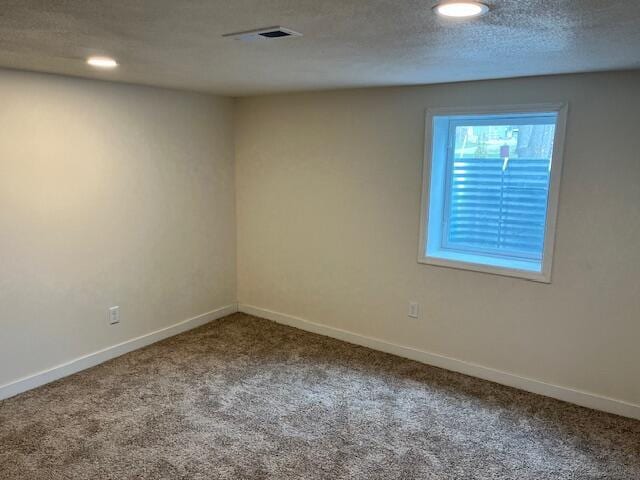 spare room with recessed lighting, visible vents, carpet flooring, and baseboards