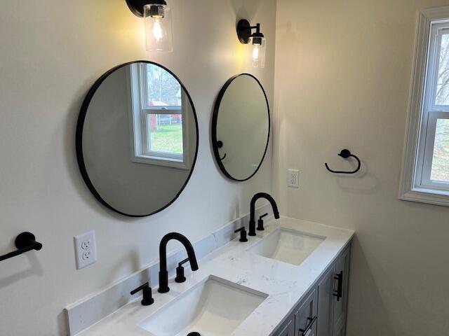 bathroom featuring a wealth of natural light and a sink