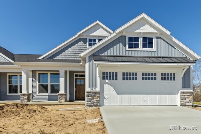 7571 Brook Villa Ct, Allendale, MI 49401 - craftsman house with board and batten siding, stone siding, and driveway