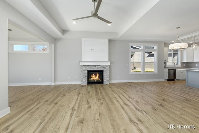 7571 Brook Villa Ct, Allendale, MI 49401 - unfurnished living room with a ceiling fan, light wood-style floors, baseboards, a fireplace, and recessed lighting