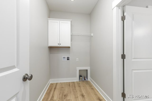 7571 Brook Villa Ct, Allendale, MI 49401 - laundry room with hookup for a washing machine, light wood-style flooring, cabinet space, and baseboards