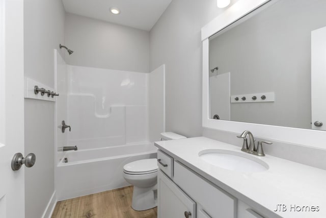 7571 Brook Villa Ct, Allendale, MI 49401 - bathroom featuring vanity, toilet, wood finished floors, and shower / tub combination