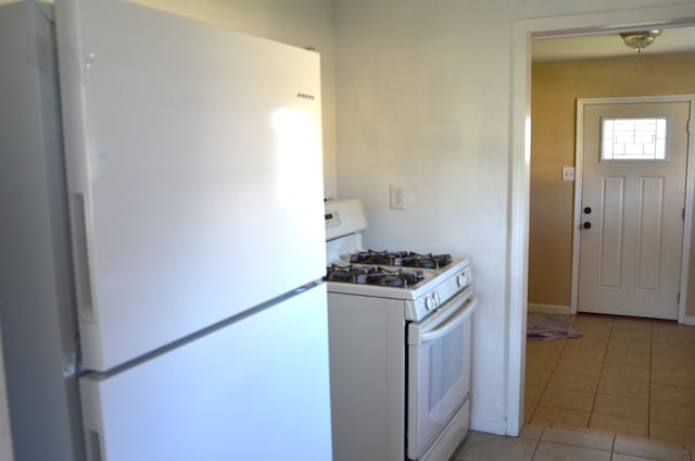 kitchen with white appliances and light tile patterned floors