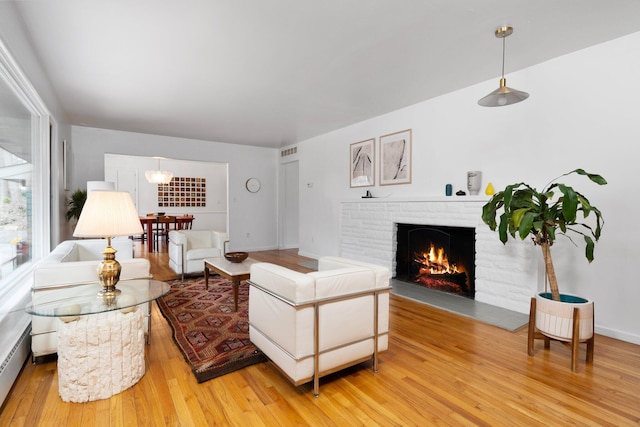1657 Glenwood Rd, Ann Arbor, MI 48104 - living room with a fireplace, light wood finished floors, and baseboard heating
