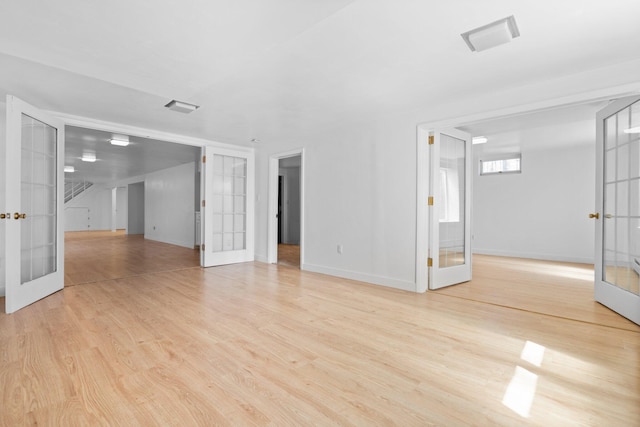 1657 Glenwood Rd, Ann Arbor, MI 48104 - spare room featuring french doors, light wood-style floors, and baseboards