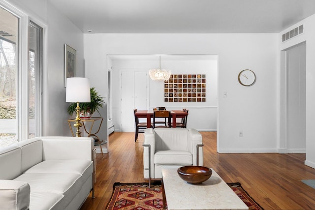 1657 Glenwood Rd, Ann Arbor, MI 48104 - living room with wood-type flooring, baseboards, and a chandelier