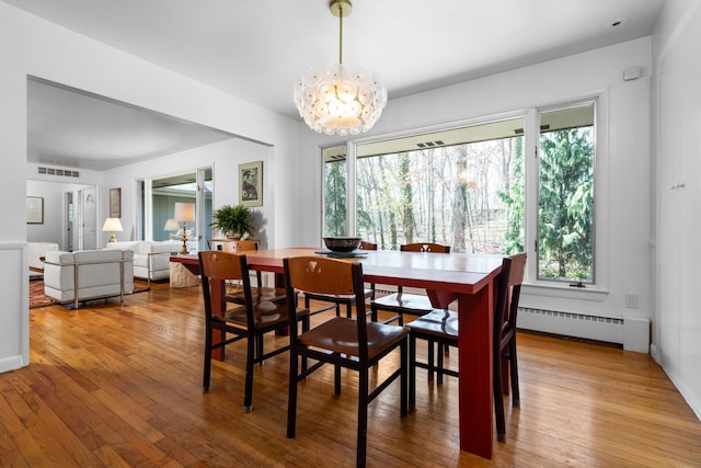 1657 Glenwood Rd, Ann Arbor, MI 48104 - dining area with a baseboard radiator, plenty of natural light, and hardwood / wood-style floors