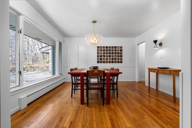 1657 Glenwood Rd, Ann Arbor, MI 48104 - dining area with a baseboard radiator, a chandelier, and hardwood / wood-style flooring