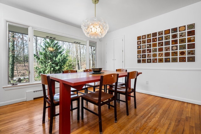 1657 Glenwood Rd, Ann Arbor, MI 48104 - dining room featuring wood-type flooring, baseboards, a chandelier, and a baseboard heating unit
