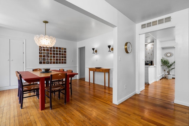 1657 Glenwood Rd, Ann Arbor, MI 48104 - dining area featuring hardwood / wood-style floors, a chandelier, and baseboards