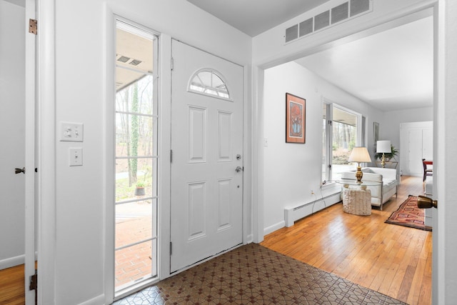 1657 Glenwood Rd, Ann Arbor, MI 48104 - foyer entrance with wood finished floors, baseboard heating, and baseboards