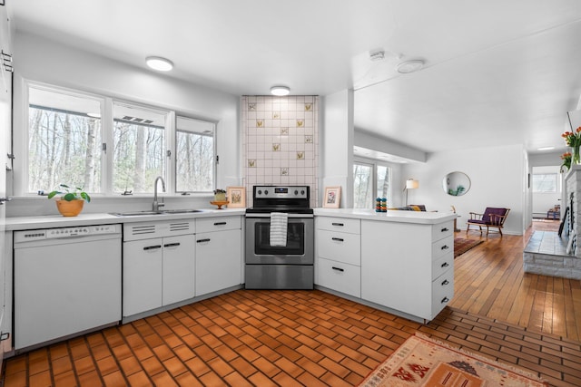 1657 Glenwood Rd, Ann Arbor, MI 48104 - kitchen with stainless steel range with electric cooktop, white dishwasher, a sink, a peninsula, and light countertops