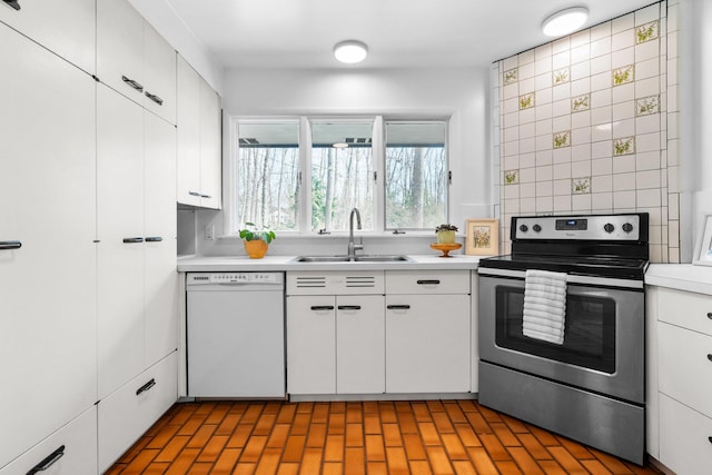 1657 Glenwood Rd, Ann Arbor, MI 48104 - kitchen featuring white dishwasher, electric stove, a sink, light countertops, and white cabinets